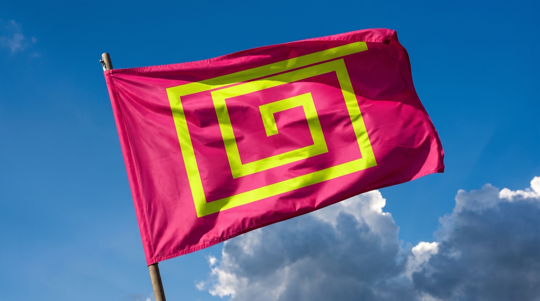 The flag of the Republic flying from a wooden staff against a blue sky